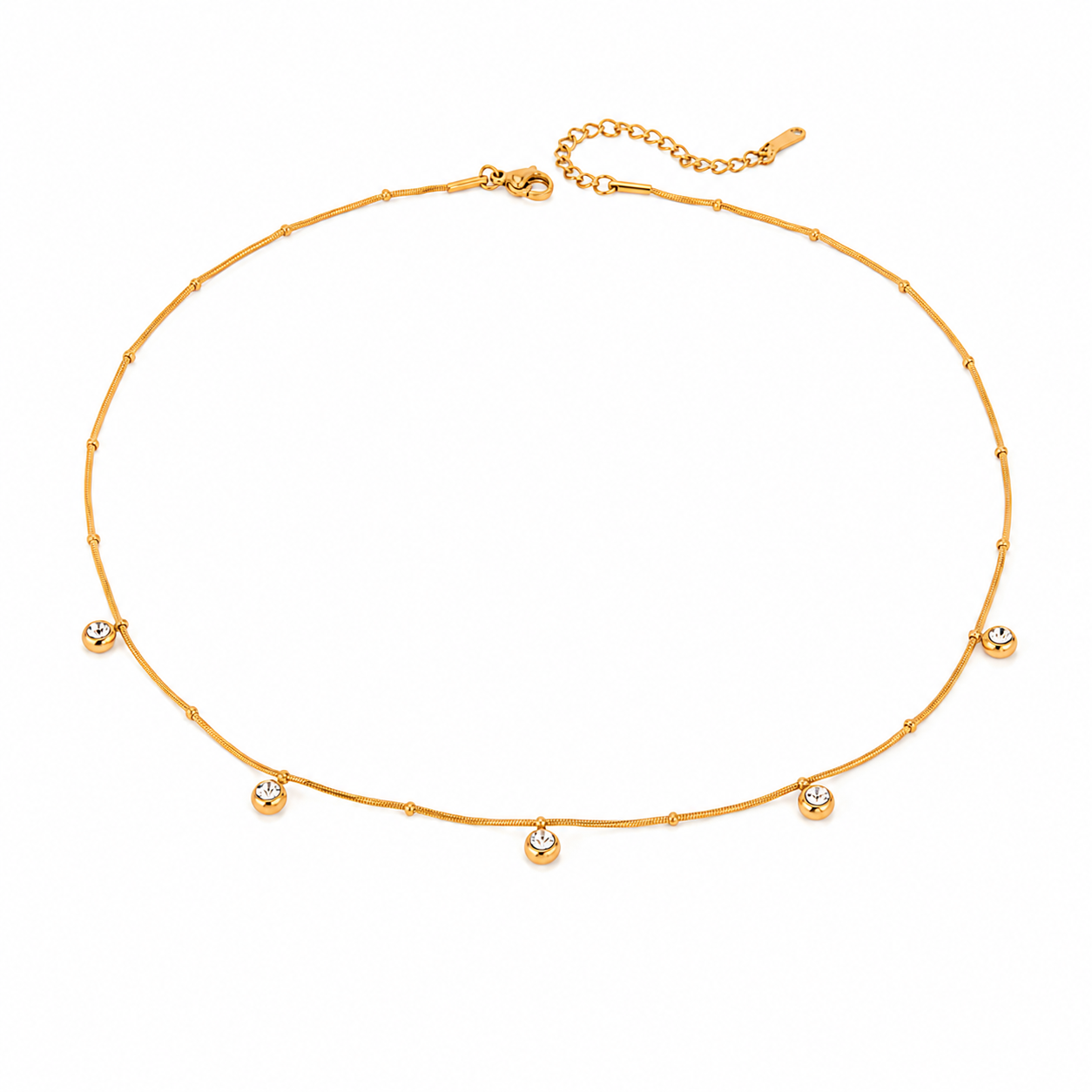 Aster Necklace featuring a delicate waterproof 18K gold PVD chain with bezel-set cubic zirconia accents worn on a model at the beach.